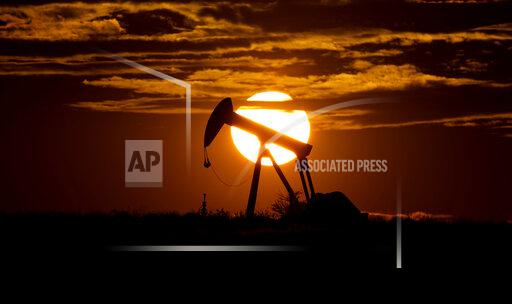 FILE - In this Wednesday, April 8, 2020 file photo, the sun sets behind an idle pump jack near Karnes City, USA. As the world's nations prepare to gather for another climate summit next month, Nov. 2021 in Glasgow, the OPEC oil cartel is reminding that, in their view, crude will continue to be the leading source of energy for decades, especially as the world's less-wealthy countries seek higher growth and standards of living. (AP Photo/Eric Gay, File)