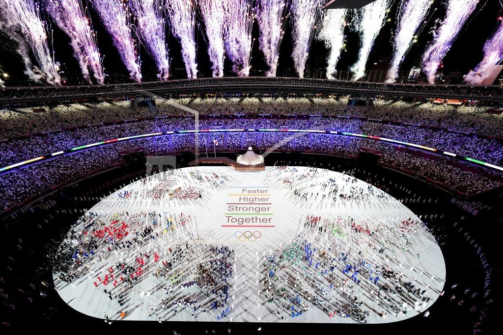 Morry Gash Athletes are seen with fireworks during the opening ceremony at the Olympic Stadium at the 2020 Summer Olympics, Friday, July 23, 2021, in Tokyo. (AP Photo/Morry Gash)