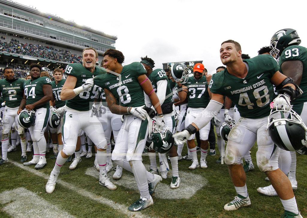 Al Goldis Michigan State players, including Matt Dotson (89), Jalen Nailor (8) and Kenny Willekes (48), celebrate following a 23-13 win over Purdue in an NCAA college football game, Saturday, Oct. 27, 2018, in East Lansing, Mich. (AP Photo/Al Goldis)