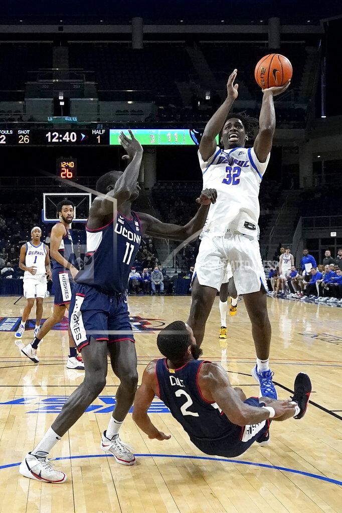 Charles Rex Arbogast DePaul's David Jones (32) shoots over Connecticut's Akok Akok and R.J. Cole during the first half of an NCAA college basketball game Saturday, Jan. 29, 2022, in Chicago. (AP Photo/Charles Rex Arbogast)