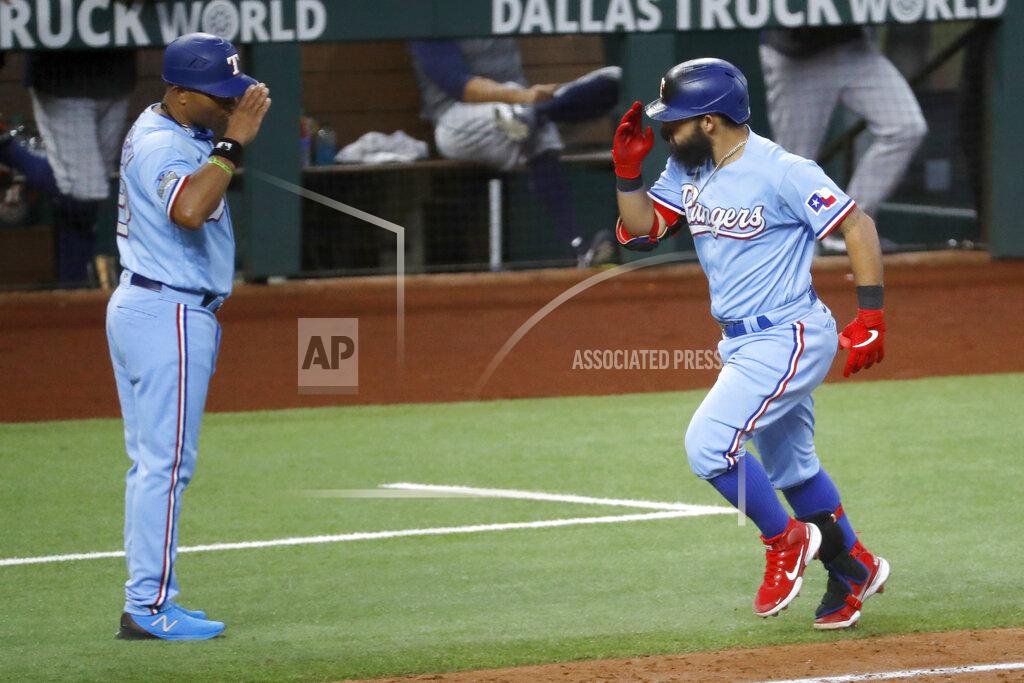 Roger Steinman Texas Rangers' Rougned Odor, right, salutes with third base coach Tony Beasley, left, after hitting his second home run of the day in the fifth inning of a baseball game against the Houston Astros in Arlington, Texas, Sunday, Sept. 27, 2020. (AP Photo/Roger Steinman)
