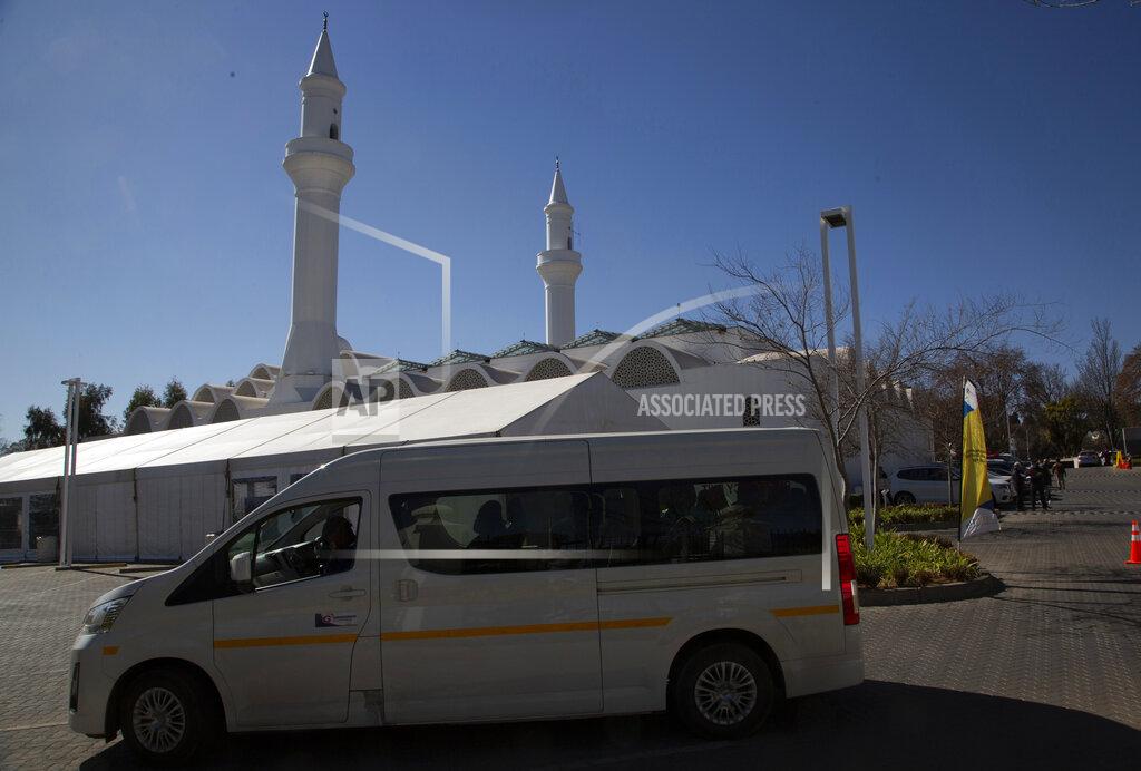 Denis Farrell A minibus vehicle arrives at the Houghton Mosque, which is being used as a drive-thru COVID-19 vaccination centre in Johannesburg, Wednesday, July 28, 2021. Hitting its stride after a faltering start, South Africa’s mass vaccination campaign gave jabs to 220,000 people a day last week and is accelerating toward the goal of 300,000 per day. With large deliveries of doses arriving and some vaccines being assembled here, South Africa appears on track to inoculate about 35 million of its 60 million people by the end of the year. (AP Photo/Denis Farrell)