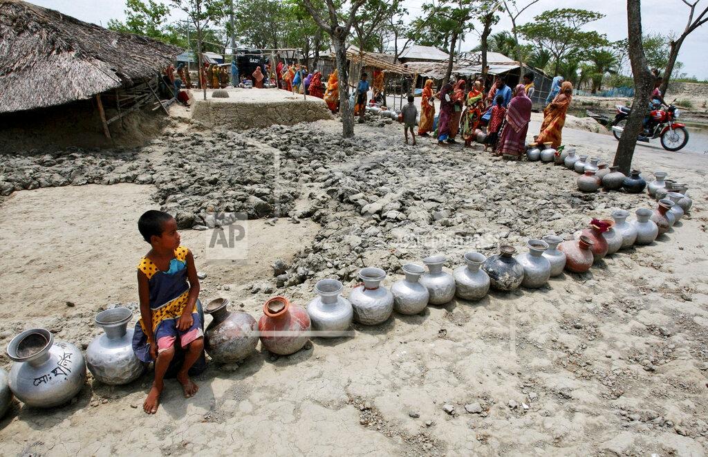 Pavel Rahman FILE - In this photo taken Friday, May 14, 2010, a girl sits on a vessel as she waits with others in a queue for water supplied by tankers at an area affected by last year's cyclone Aila in Nildumur, Satkhira district, about 176 kilometers (110 miles) southwest of the capital Dhaka, Bangladesh. Bangladesh plans to present its “climate prosperity plan” aimed at mitigating the effects of global warming on economic development at the forthcoming U.N. climate talks in Glasgow, Bangladeshi climate officer Abul Kalam Azad said in an interview with The Associated Press on Friday, Oct. 22, 2021. With most of its 160 million people tightly packed into low-lying areas along the Bay of Bengal, Bangladesh is considered especially prone to flooding, extreme weather and the loss of farmland to rising ocean levels. (AP Photo/Pavel Rahman, File)