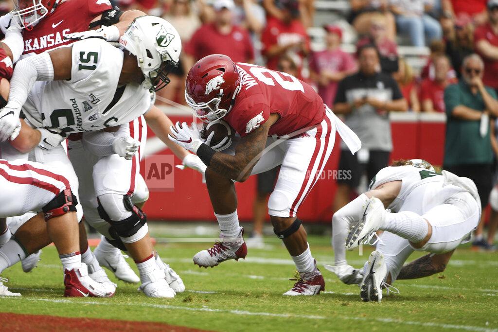 Michael Woods Arkansas running back Devwah Whaley (21) slips past Portland State defender Kenton Bartlett (51) to score a touchdown in the first half of an NCAA college football game, Saturday, Aug. 31, 2019 in Fayetteville, Ark. (AP Photo/Michael Woods)
