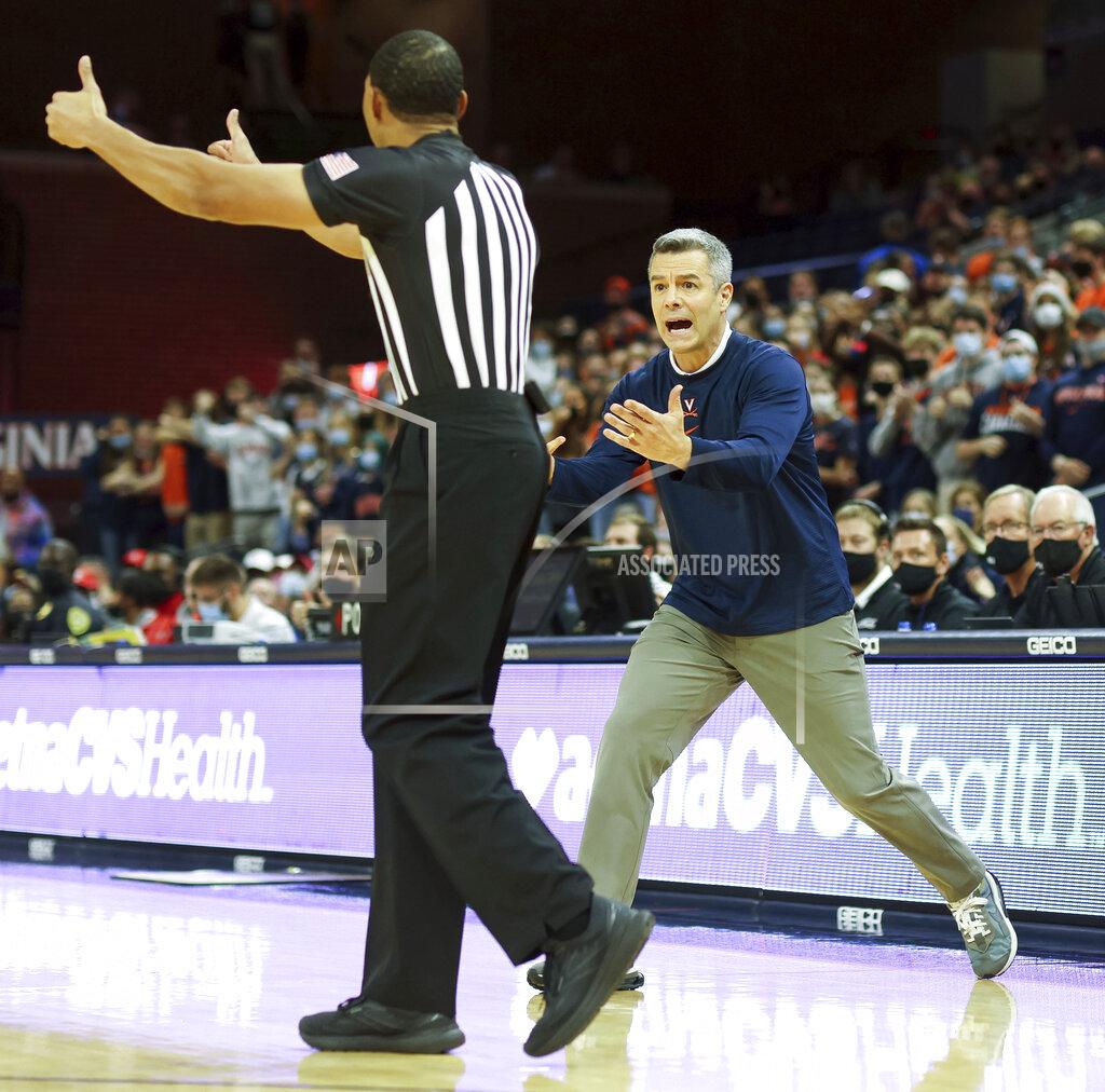 Andrew Shurtleff CORRECTS OPPOSITION TO RADFORD, NOT COPPIN STATE - Virginia head coach Tony Bennett reacts to a call during an NCAA college basketball game against Radford in Charlottesville, Va., Friday, Nov. 12, 2021. (AP Photo/Andrew Shurtleff)