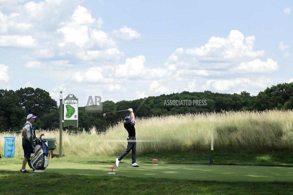 Frank Franklin Ii Matt Wallace, right, of England, tees off on the third hole as caddie David McNeilly looks on during the second round of the Travelers Championship golf tournament at TPC River Highlands, Friday, June 26, 2020, in Cromwell, Conn. Wallace is playing the second round by himself after two other golfers in his group, Denny McCarthy and Bud Cauley, withdrew from the tournament. McCarthy told Golfchannel.com that he withdrew from the tournament after feeling sick Thursday night and testing positive for the coronavirus on Friday. Cauley, who played with McCarthy on Thursday, also withdrew before Friday's second round. McCarthy became the third PGA Tour player to test positive for the virus since its restart and the second this week, joining Cameron Champ who withdrew on Tuesday. Nick Watney withdrew just before the second round of last week's RBC Heritage Championship. (AP Photo/Frank Franklin II)