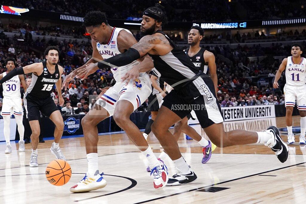 Charles Rex Arbogast Providence's Nate Watson knocks the ball from Kansas' David McCormack during the first half of a college basketball game in the Sweet 16 round of the NCAA tournament Friday, March 25, 2022, in Chicago. (AP Photo/Charles Rex Arbogast)