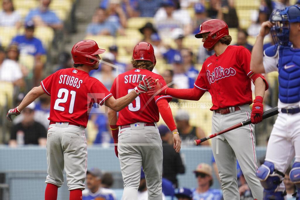 Ashley Landis Philadelphia Phillies Garrett Stubbs (21) and Bryson Stott (5) celebrate with designated hitter Alec Bohm, right, after they both scored off of a single hit by Rhys Hoskins during the second inning of a baseball game against the Los Angeles Dodgers in Los Angeles, Sunday, May 15, 2022. (AP Photo/Ashley Landis)