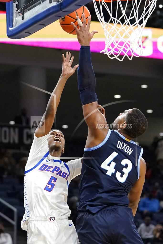Nam Y. Huh Villanova forward Eric Dixon, right, blocks a shot by DePaul guard Philmon Gebrewhit during the second half of an NCAA college basketball game in Chicago, Saturday, Jan. 8, 2022. Villanova won 79-64. (AP Photo/Nam Y. Huh)
