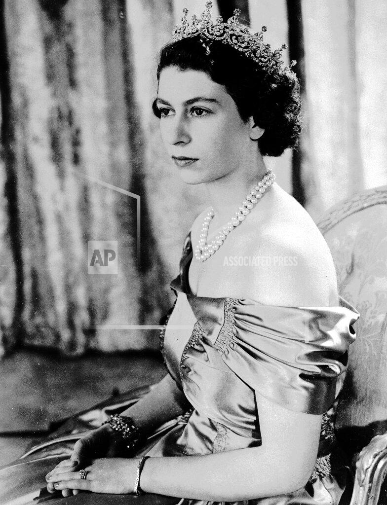 Uncredited FILE - Britain's Queen Elizabeth II, then Princess Elizabeth, wears a silver gown with a diamond tiara and pearl necklace, in this Aug. 30, 1949 photo. (AP Photo, File)