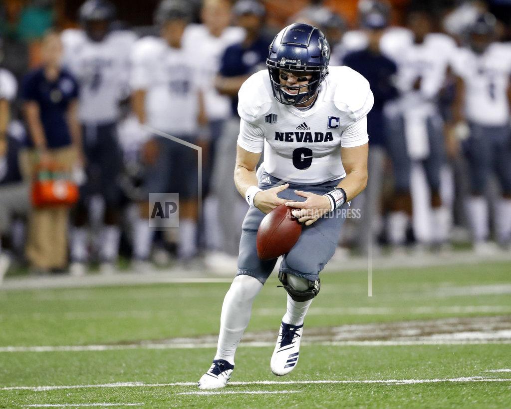 Marco Garcia Nevada quarterback Kaymen Cureton (8) fumbles the ball but regains it as he runs against Hawaii during the second quarter of an NCAA college football game, Saturday, Oct. 20, 2018, in Honolulu. (AP Photo/Marco Garcia)
