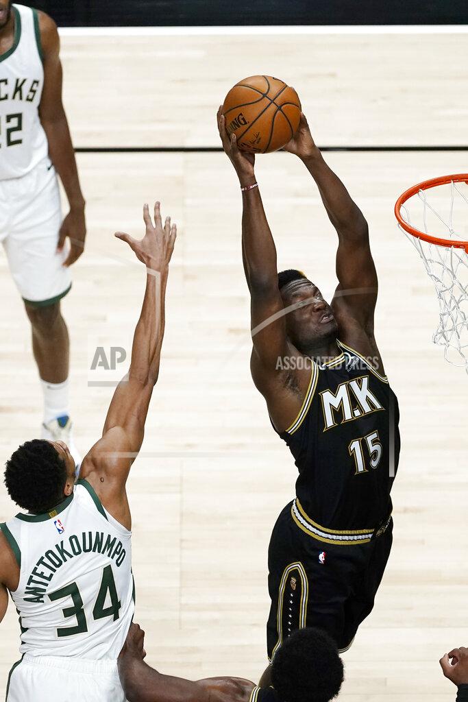 John Bazemore Atlanta Hawks center Clint Capela (15) scores as Milwaukee Bucks forward Giannis Antetokounmpo (34) defends during the first half of an NBA basketball game Thursday, April 15, 2021, in Atlanta. (AP Photo/John Bazemore)