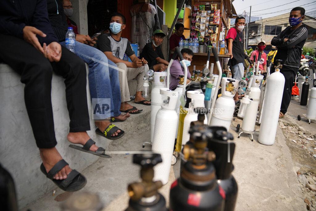Dita Alangkara In this July 5, 2021, file photo, people queue up to refill their oxygen tanks at a filling station in Jakarta, Indonesia. Images of bodies burning in open-air pyres during the peak of the pandemic in India horrified the world in May, but in the last two weeks Indonesia and two other Southeast Asian nations have surpassed India’s peak per capita death rate as a new coronavirus wave tightens its grip on the region. (AP Photo/Dita Alangkara, File)