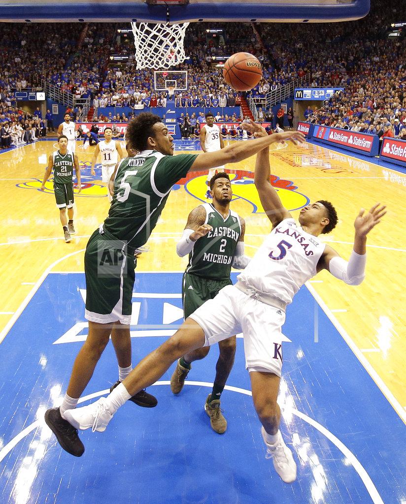 Charlie Riedel Kansas' Quentin Grimes (5) puts up a shot under pressure from Eastern Michigan's Elijah Minnie (5) during the first half of an NCAA college basketball game Saturday, Dec. 29, 2018, in Lawrence, Kan. (AP Photo/Charlie Riedel)