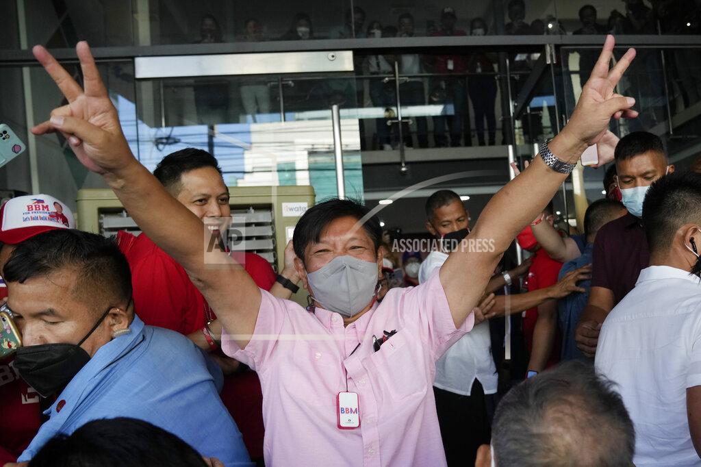 Aaron Favila Presidential candidate Ferdinand "Bongbong" Marcos Jr. gestures as he greets the crowd outside his headquarters in Mandaluyong, Philippines on Wednesday, May 11, 2022. Marcos, the namesake son of longtime dictator Ferdinand Marcos, apparent landslide victory in the Philippine presidential election is raising immediate concerns about a further erosion of democracy in Asia and could complicate American efforts to blunt growing Chinese influence and power in the Pacific. (AP Photo/Aaron Favila)