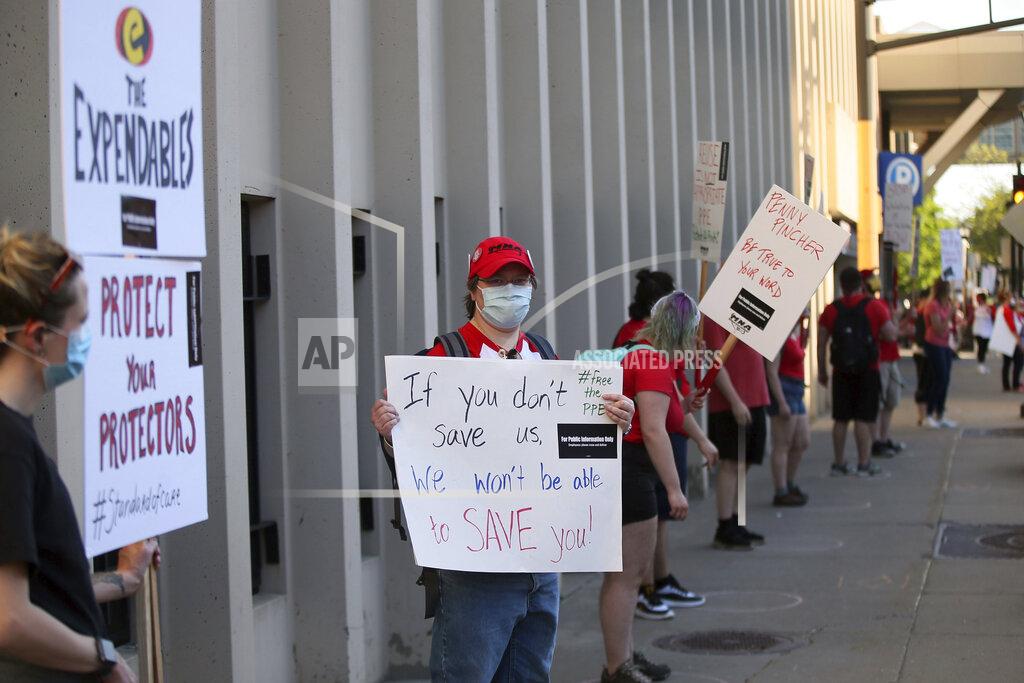 Jim Mone Nurses picket United Hospital, Wednesday, May 20, 2020, in St. Paul, Minn., as they seek a say in worker protections, increased personal protection resources with higher safety standards and an end to retaliation against workers who have tried to protect themselves from the coronavirus. (AP Photo/Jim Mone)