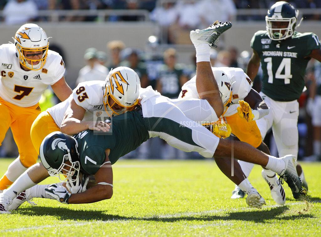 Al Goldis Michigan State's Cody White (7) is stopped by Arizona State's Erik Dickerson (93) and Evan Fields (4) during the first quarter of an NCAA college football game Saturday, Sept. 14, 2019, in East Lansing, Mich. (AP Photo/Al Goldis)