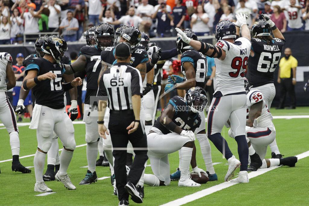 David J. Phillip Houston Texans defensive end J.J. Watt (99) signals after Jacksonville Jaguars running back Leonard Fournette (27) was held short of the goal line on a two-point conversion attempt during the second half of an NFL football game Sunday, Sept. 15, 2019, in Houston. (AP Photo/David J. Phillip)