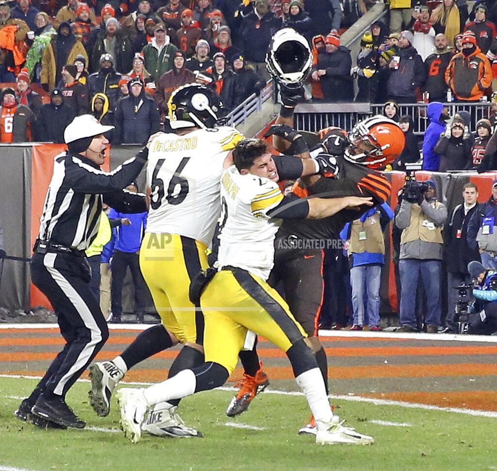 Joshua Gunter Cleveland Browns defensive end Myles Garrett (95) hits Pittsburgh Steelers quarterback Mason Rudolph (2) with a helmet during the second half of an NFL football game Thursday, Nov. 14, 2019, in Cleveland. (Joshua Gunter/Cleveland.com via AP)
