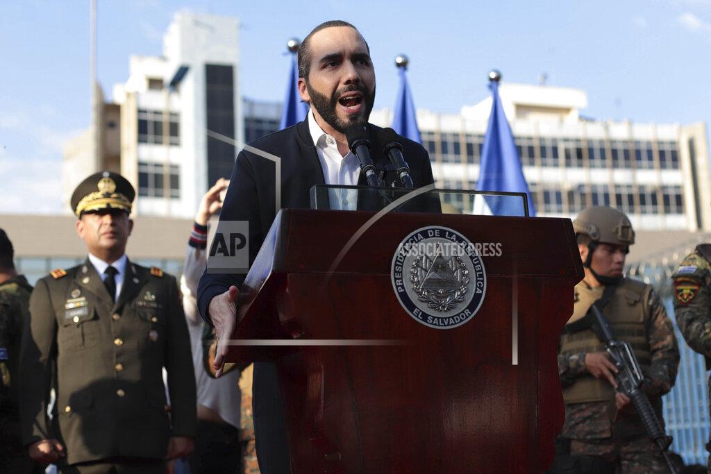 FILE - In this Feb. 9, 2020 file photo, El Salvador's President Nayib Bukele, accompanied by members of the armed forces, speaks to supporters outside Congress in San Salvador, El Salvador. Bukele has imposed some of the region's toughest measures against the new coronavirus and a growing number of human rights advocates at home and abroad complain the 38-year-old leader has used the emergency to seize near-dictatorial powers. (AP Photo/Salvador Melendez, File)