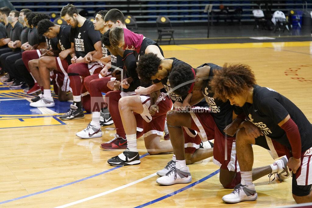 Jeff Chiu Washington State players kneel during the national anthem before an NCAA college basketball game against Stanford in Santa Cruz, Calif., Saturday, Jan. 9, 2021. (AP Photo/Jeff Chiu)