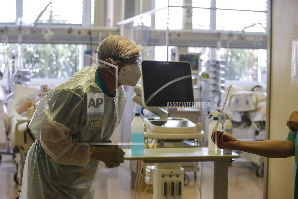 Luca Bruno Doctor Davide Maraggia works in the Intensive Care Unit of the Varese’s Circolo Hospital, in Varese, Italy, Friday, Nov. 6, 2020. During Italy's autumn pandemic resurgence, concern is falling less on intensive care wards and more on regular medical wards, as eight regions have seen the needle move alarmingly into the red-alert zone with more than half of hospital beds dedicated to coronavirus patients. (AP Photo/Luca Bruno)