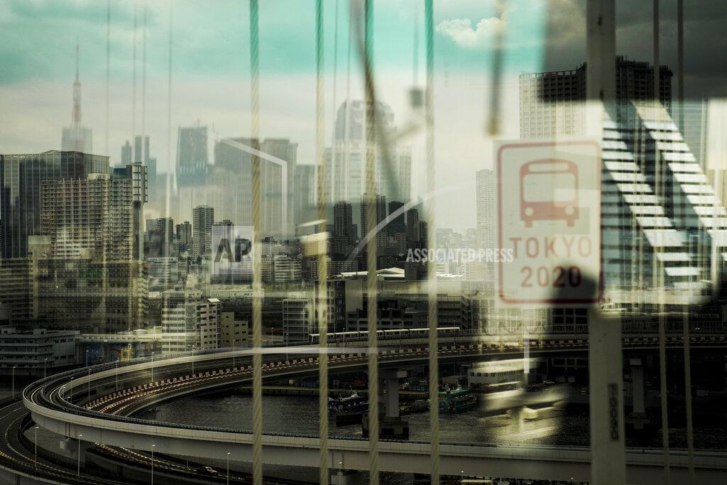 Jae C. Hong The skyline of Tokyo is seen through a bus window from the Rainbow Bridge ahead of the 2020 Summer Olympics, Wednesday, July 14, 2021, in Tokyo. (AP Photo/Jae C. Hong)