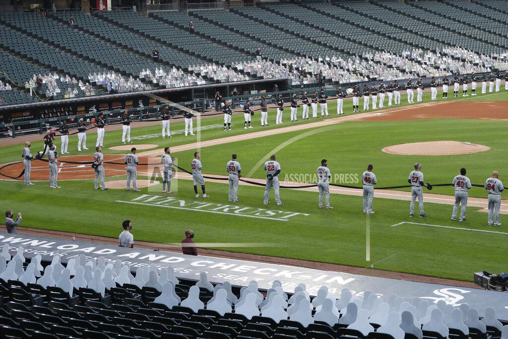 Charles Rex Arbogast The Chicago White Sox, top, and Minnesota Twins hold a black ribbon for social justice before the White Sox's home opener baseball game Friday, July 24, 2020, in Chicago. (AP Photo/Charles Rex Arbogast)