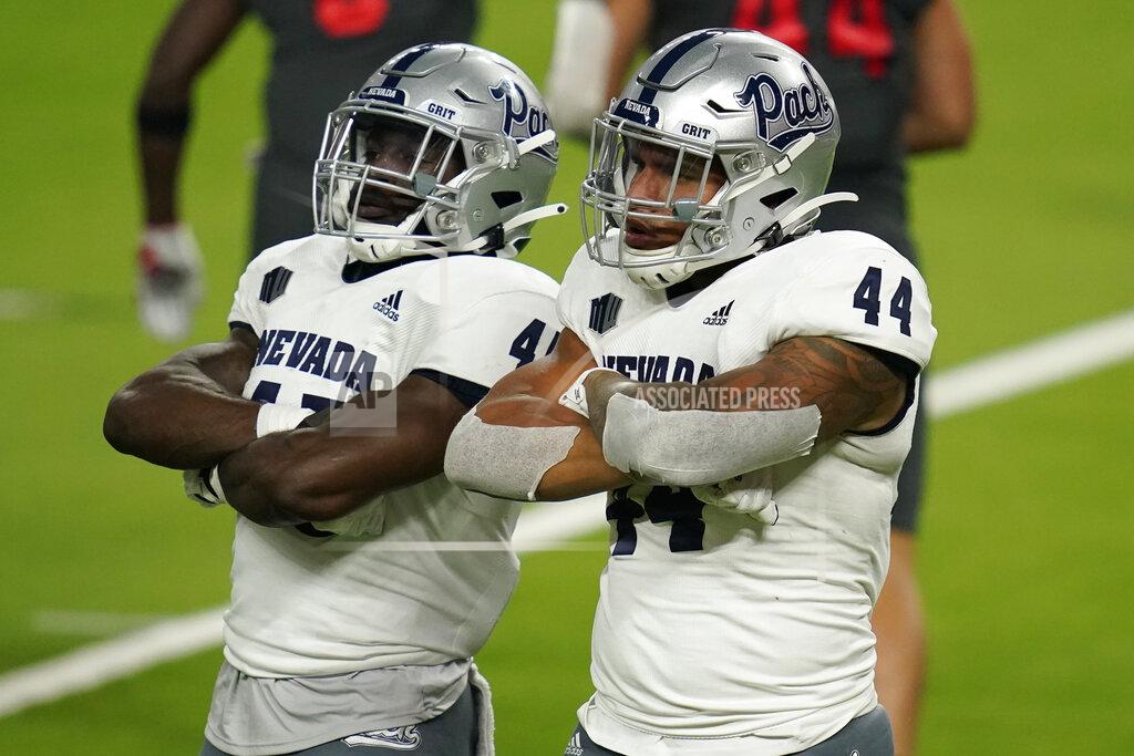 John Locher Nevada linebacker Trevor Price, left, and defensive end Daniel Grzesiak (44) celebrate after a play against UNLV during the second half of an NCAA college football game Saturday, Oct. 31, 2020, in Las Vegas. (AP Photo/John Locher)