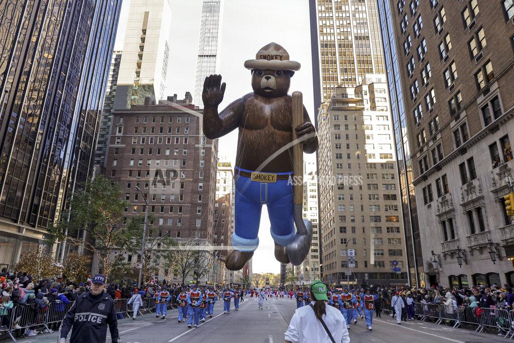 Jeenah Moon Handlers pull the Smokey Bear balloon down Sixth Avenue during the Macy's Thanksgiving Day Parade, Thursday, Nov. 24, 2022, in New York. (AP Photo/Jeenah Moon)