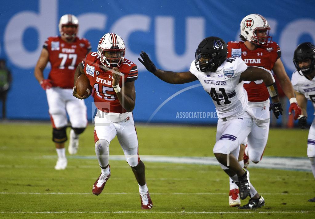 Denis Poroy Utah quarterback Jason Shelley (15) runs away from Northwestern safety Jared McGee (41) on his way to a first down during the first half of the Holiday Bowl NCAA college football game against Utah, Monday, Dec. 31, 2018, in San Diego. (AP Photo/Denis Poroy)