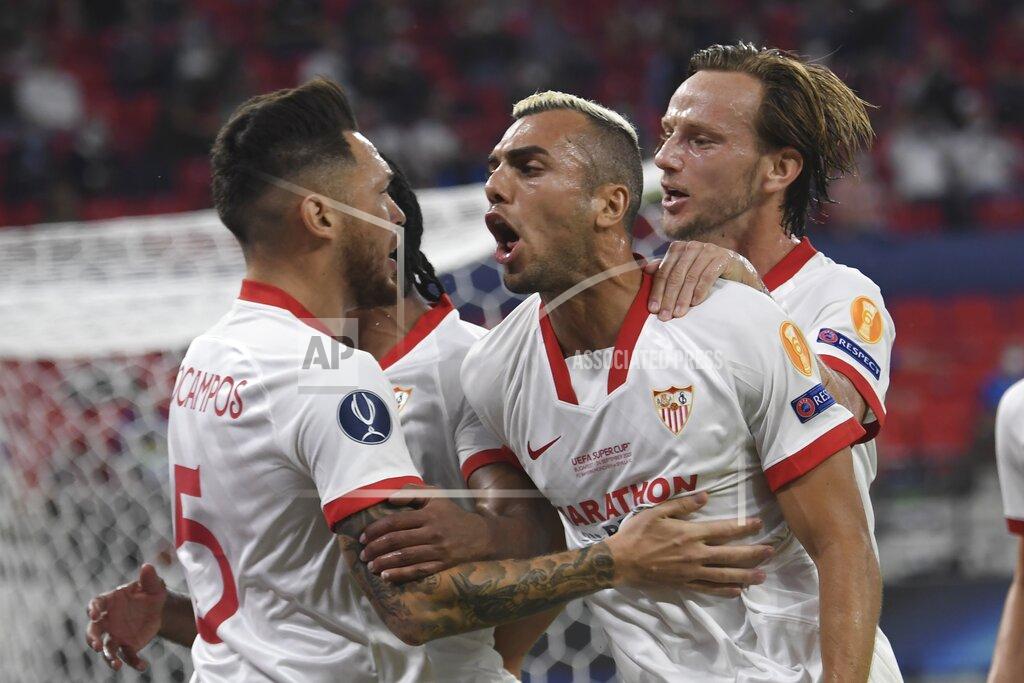Attila Kisbenedek Sevilla's Lucas Ocampos, left, celebrates with his teammates after scoring the opening goal during the UEFA Super Cup soccer match between Bayern Munich and Sevilla at the Puskas Arena in Budapest, Hungary, Thursday, Sept. 24, 2020. (Attila Kisbenedek/Pool via AP)