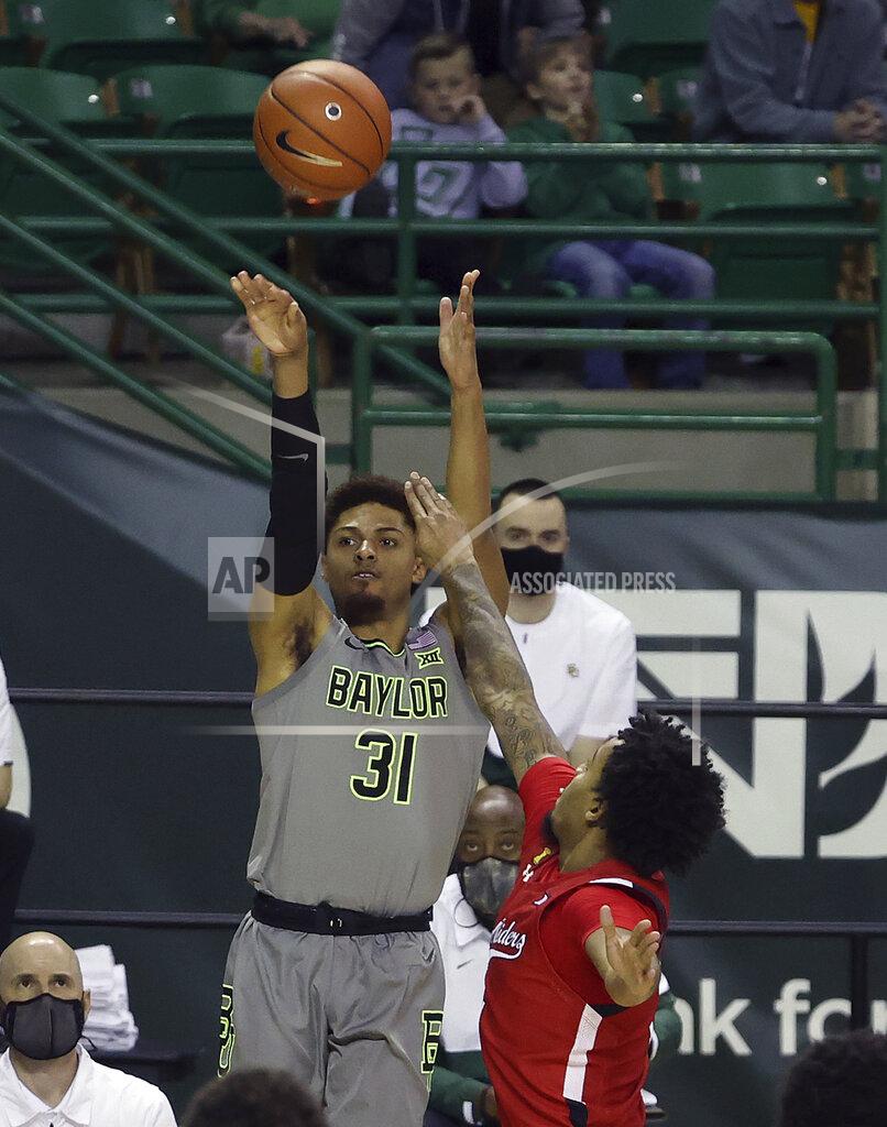 Jerry Larson Baylor guard MaCio Teague (31) shoots a three-point basket over Texas Tech guard Kyler Edwards in the second half of an NCAA college basketball game Sunday, March 7, 2021, in Waco, Texas. (AP Photo/Jerry Larson)