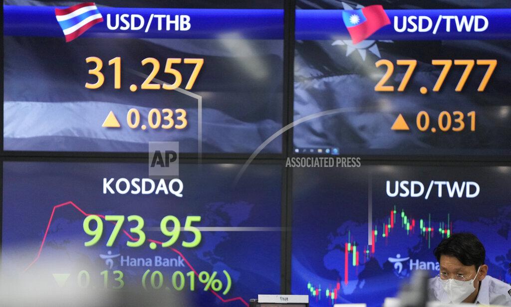 Lee Jin-Man A currency trader watches computer monitors near the screens showing the Korean Securities Dealers Automated Quotations (KOSDAQ), left, and the foreign exchange rates at the foreign exchange dealing room in Seoul, South Korea, Friday, May 28, 2021. Asian shares rose Friday, powered by encouraging signs that the U.S. economic recovery from the pandemic is gaining momentum. (AP Photo/Lee Jin-man)