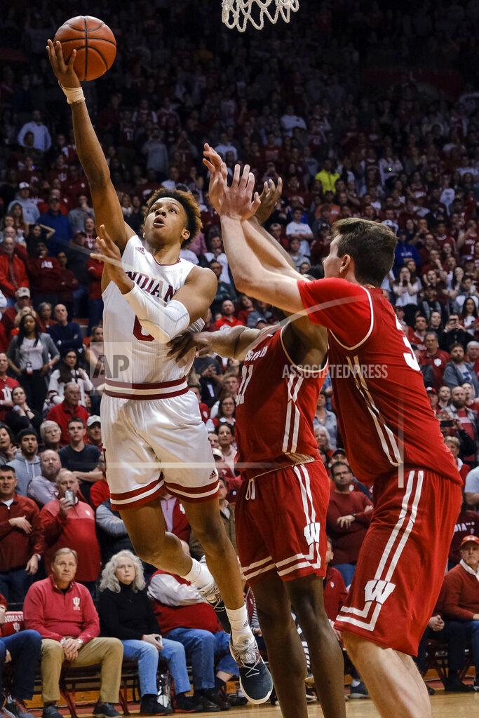 Aj Mast Indiana guard Romeo Langford, left, shoots and scores next to Wisconsin defenders guard Khalil Iverson, center, and Nate Reuvers during the second overtime of an NCAA college basketball game in Bloomington, Ind., Tuesday, Feb. 26, 2019. Indiana won 75-73. (AP Photo/AJ Mast)