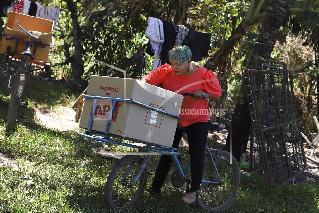 Salvador Melendez Iris Franco is seen at her home in El Ranchador, Santa Ana, El Salvador, Friday, March 5, 2021. Franco runs a bakery at home and delivers the bread on a bike. The Salvadoran family lives humbly but is in a better place thanks to financial support from a family member in the United States who is part of the Temporary Protected Status program. (AP Photo/Salvador Melendez)