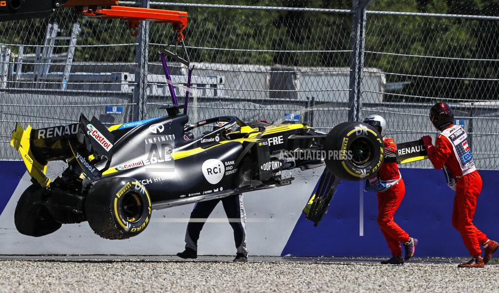 Leonhard Foeger The car of Renault driver Daniel Ricciardo of Australia is lifted after crashing into the barriers during the second practice session for the Styrian Formula One Grand Prix at the Red Bull Ring racetrack in Spielberg, Austria, Friday, July 10, 2020. The Styrian F1 Grand Prix will be held on Sunday. (Leonhard Foeger/Pool via AP)