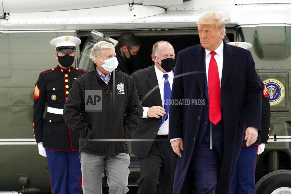 Alex Brandon Sen. Lindsey Graham, R-S.C., left, walks with President Donald Trump as they board Air Force One upon arrival at Valley International Airport, Tuesday, Jan. 12, 2021, in Harlingen, Texas, after visiting a section of the border wall with Mexico in Alamo, Texas. (AP Photo/Alex Brandon)