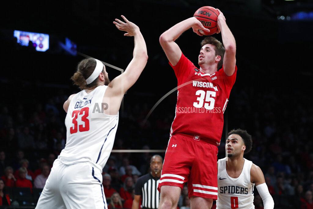 Kathy Willens Wisconsin forward Nate Reuvers (35) shooots as Richmond forward Grant Golden (33) defends during the first half of an NCAA college basketball game in the Legends Classic, Monday, Nov. 25, 2019, in New York. (AP Photo/Kathy Willens)