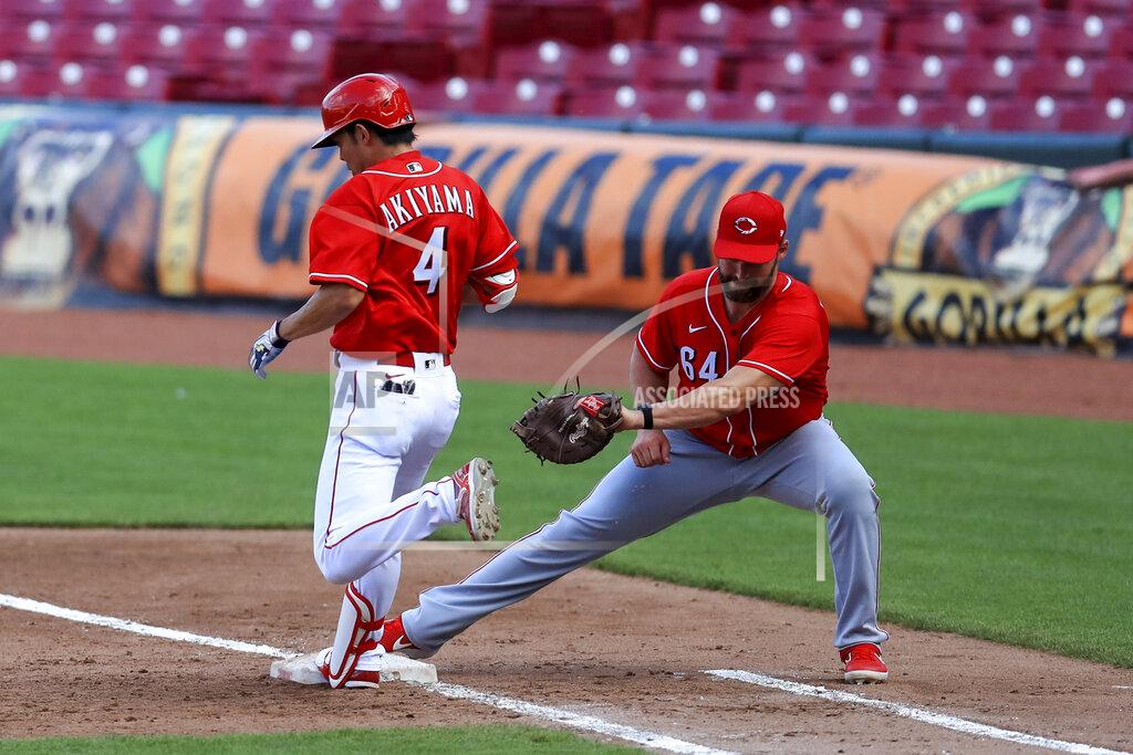 Aaron Doster Cincinnati Reds' Shogo Akiyama (4) is out at first base as Matt Davidson (64) fields the ball during an intrasquad baseball game in Cincinnati, Tuesday, July 14, 2020. (AP Photo/Aaron Doster)