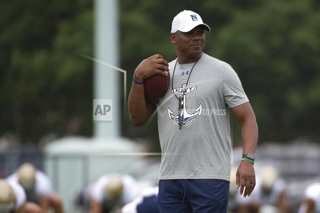 Tommy Gilligan FILE - In this Aug. 2, 2019, file photo, Navy offensive coordinator Ivin Jasper holds a football during NCAA college football training camp in Annapolis, Md. Navy coach Ken Niumatalolo decided to make some drastic changes after last year’s disappointing season. Niumatalolo brought in Billy Ray Stutzmann from Hawaii as an assistant coach/offensive assistant to help offensive coordinator Ivin Jasper add more passing elements to the Midshipmen’s traditional triple-option attack. (AP Photo/Tommy Gilligan, File)