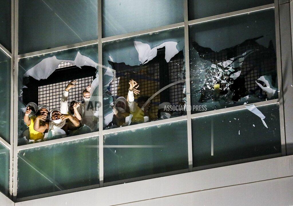Colter Peterson Inmates in a second cell block break windows and chant at the St. Louis Justice Center, known as the city jail, on Sunday, April 4, 2021. Inmates broke windows, set a fire and threw debris to the ground late Sunday at a St. Louis jail that has been plagued by uprisings in recent months. (Colter Peterson/St. Louis Post-Dispatch via AP)