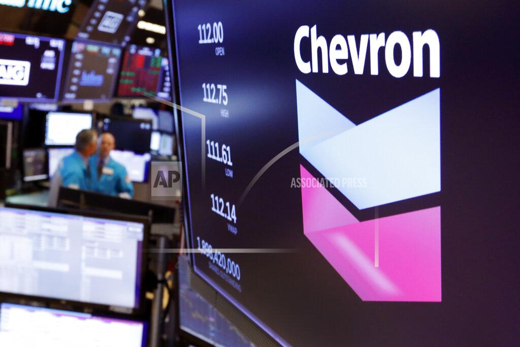 Richard Drew FILE - This Oct. 8, 2019, file photo the logo for Chevron appears above a trading post on the floor of the New York Stock Exchange. Chevron Corp. lost $8.27 billion during the quarter, Friday, July 31, 2020, a sharp contrast to the $4.3 billion it brought in during the same quarter last year. The quarter was one of the worst on record for the oil industry. (AP Photo/Richard Drew, File)