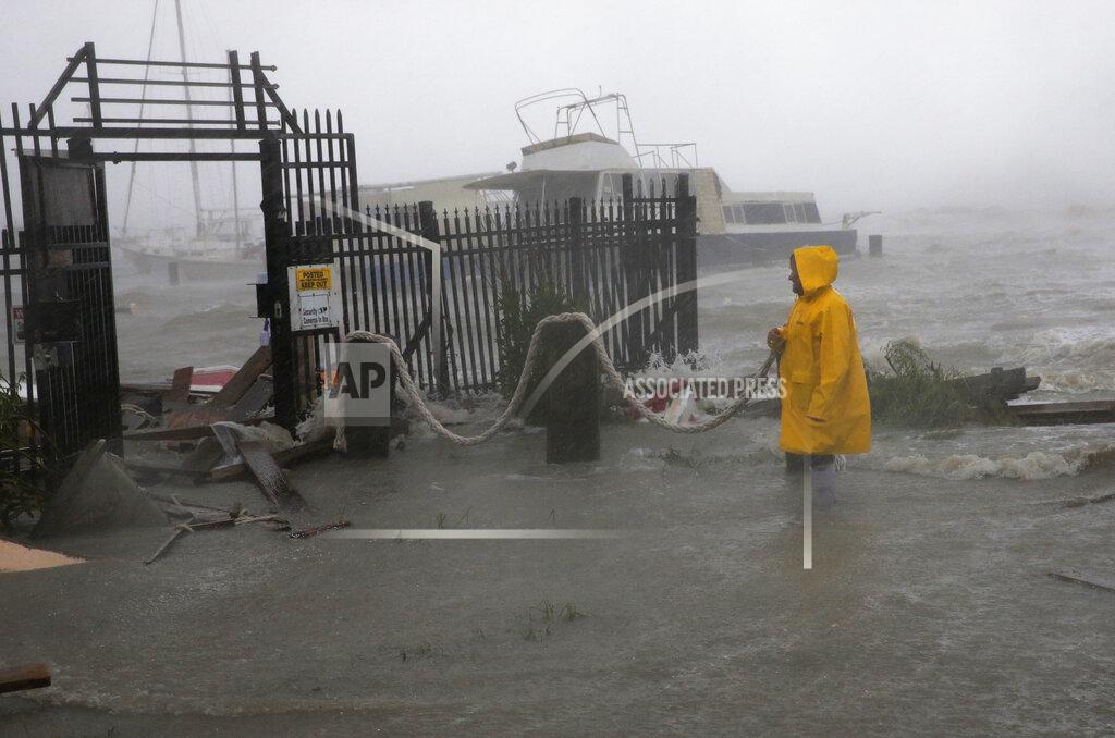 Eric Gay Jame Rowles examines the damage after the docks at the marina where his boat was secured were destroyed as Hurricane Hanna made landfall, Saturday, July 25, 2020, in Corpus Christi, Texas. (AP Photo/Eric Gay)