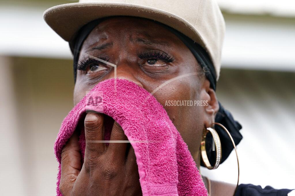 Gerald Herbert Rakisha Murray cries in relief as she arrives to see her mother's home undamaged, after she returned from evacuation with her mother and other family in Lake Charles, La., in the aftermath of Hurricane Laura, Sunday, Aug. 30, 2020. (AP Photo/Gerald Herbert)