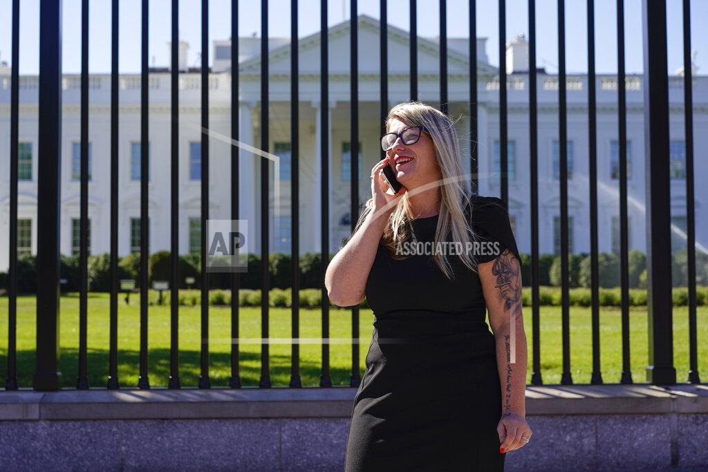 Carolyn Kaster Courtney Allen an organizer for Mobilize Recovery and on the settlement advisory council for the state of Maine, talks on her cell on Pennsylvania Avenue in front of the White House in Washington, Friday, Sept. 23, 2022. Allen and others are in Washington to meet with Doug Emhoff, husband of Vice President Kamala Harris, to give their recommendations for the distribution of the federal settlement money as billions of dollars in opioid lawsuit settlements are starting to flow to governments. (AP Photo/Carolyn Kaster)