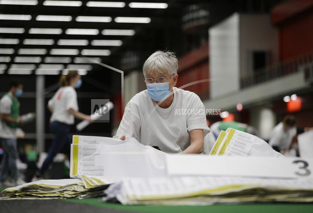 Peter Dejong Ballot papers are being sorted prior to the counting of votes in general election in Amsterdam, Netherlands, Wednesday, March 17, 2021. The election was spread over three days to allow people to vote safely during the coronavirus pandemic, an exit poll published immediately after voting ended in the Dutch general election suggested that the conservative party of caretaker Prime Minister Mark Rutte has won the most seats, putting him first in line to form a new ruling coalition. (AP Photo/Peter Dejong)