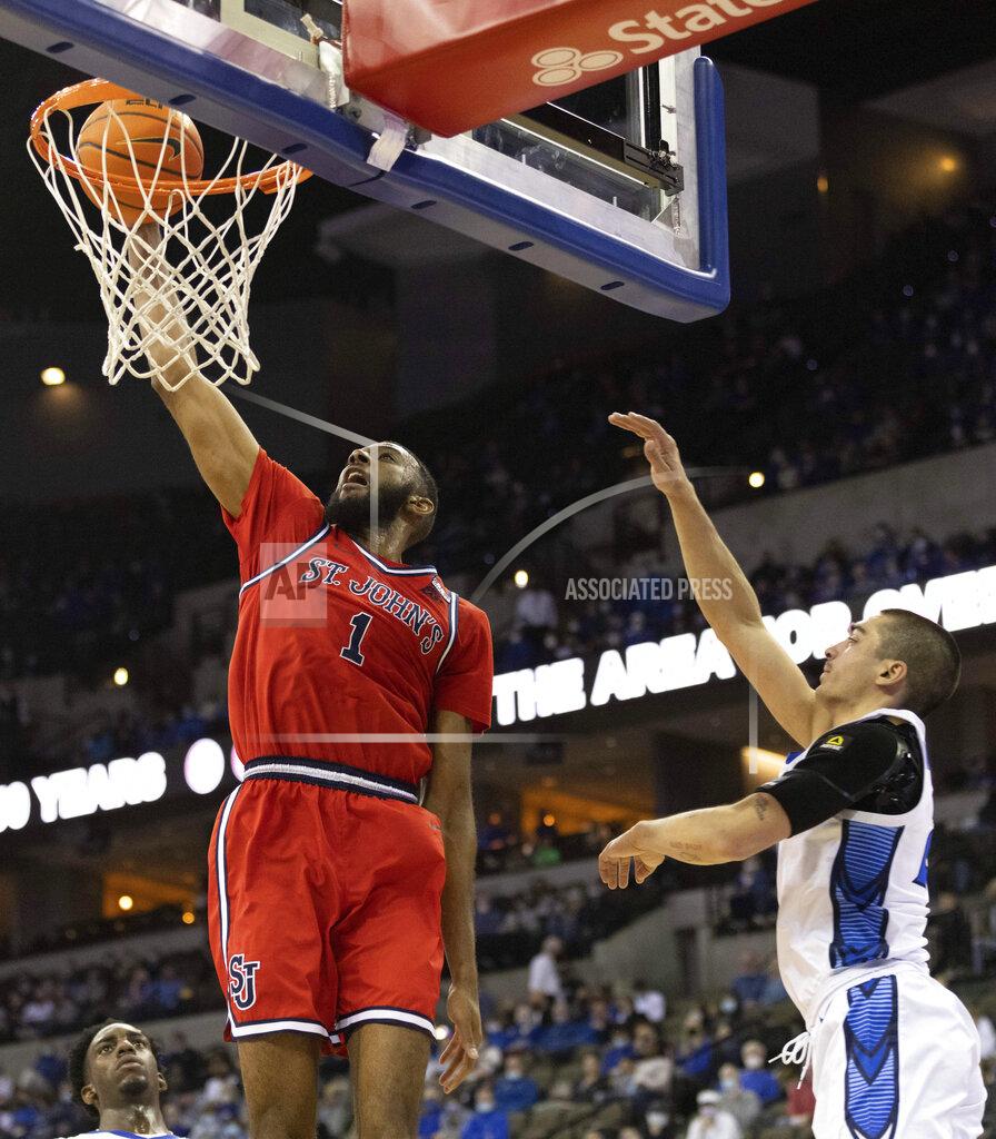 Rebecca S. Gratz St. John's Aaron Wheeler (1) dunks against Creighton's Rati Andronikashvili (21) during the second half of an NCAA college basketball game Wednesday, Jan. 19, 2022, in Omaha, Neb. Creighton defeated St. John's 87-64. (AP Photo/Rebecca S. Gratz)