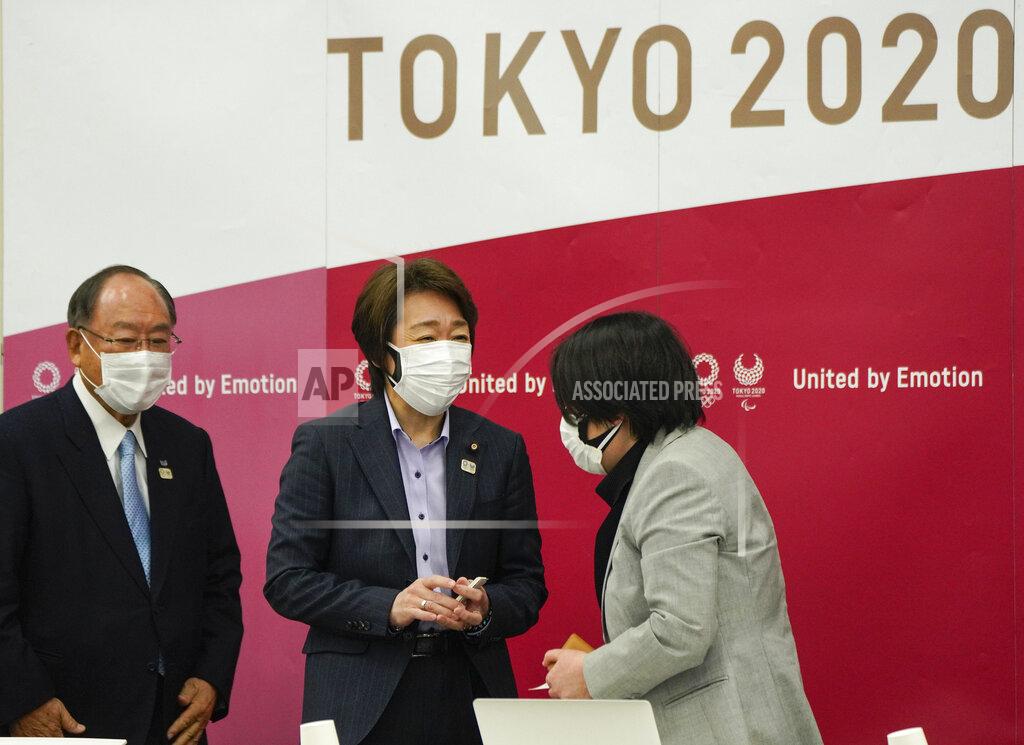 Kimimasa Mayaa Seiko Hashimoto, center, President of the Tokyo 2020 Organizing Committee of the Olympic and Paralympic Games, talks with Kyoko Raita, right, Tokyo 2020 Executive Board member and speaker for a presentation on the Olympic Charter and Gender Equality in Tokyo, Japan, Monday, March 22, 2021. Fujio Mitarai, Honorary President of Tokyo 2020, is at left. Hashimoto said they will take all possible COVID-19 countermeasures as the torch relay opens this Thursday from northeastern Fukushima prefecture. (Kimimasa Mayama/Pool Photo via AP)