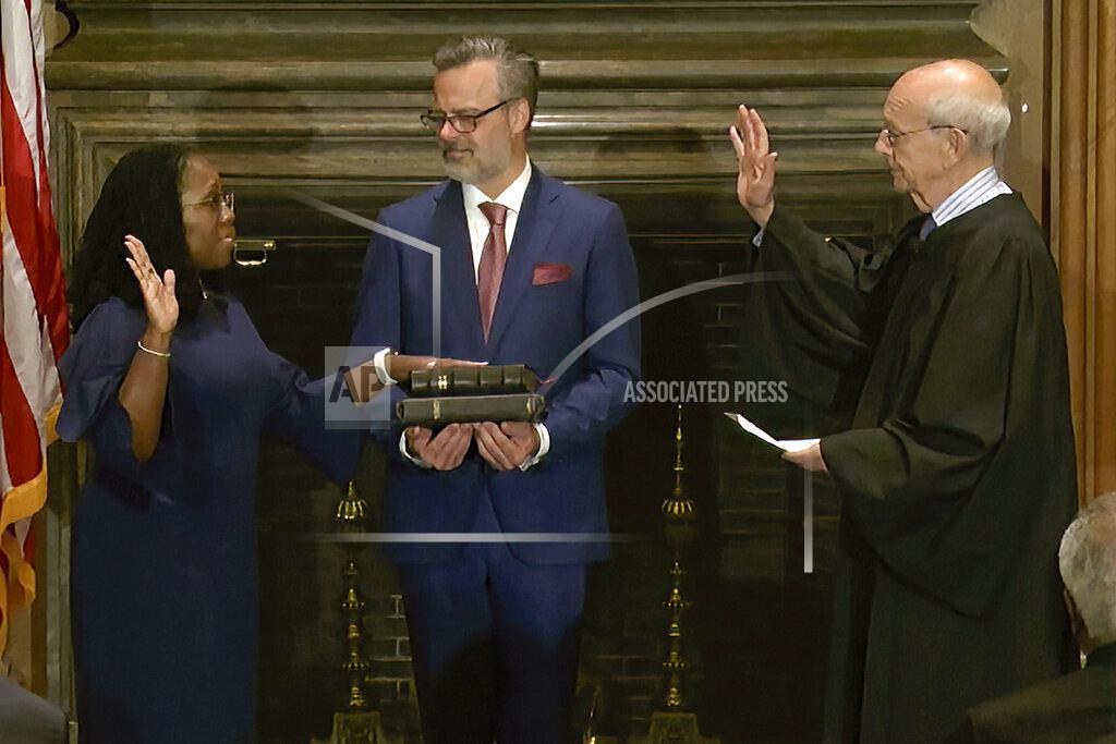 Uncredited In this image from video provided by the Supreme Court, retired Supreme Court Associate Justice Stephen Breyer administers the Judicial Oath to Ketanji Brown Jackson as her husband Patrick Jackson holds the Bible at the Supreme Court in Washington, Thursday, June 30, 2022. (Supreme Court via AP)